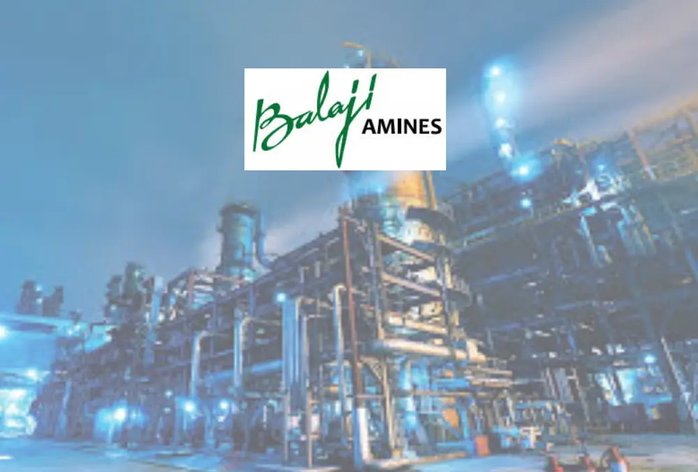 Balaji Amines logo over industrial chemical plant at night