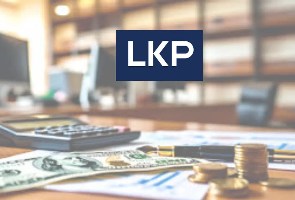 LKP logo over desk with calculator, cash, and coins