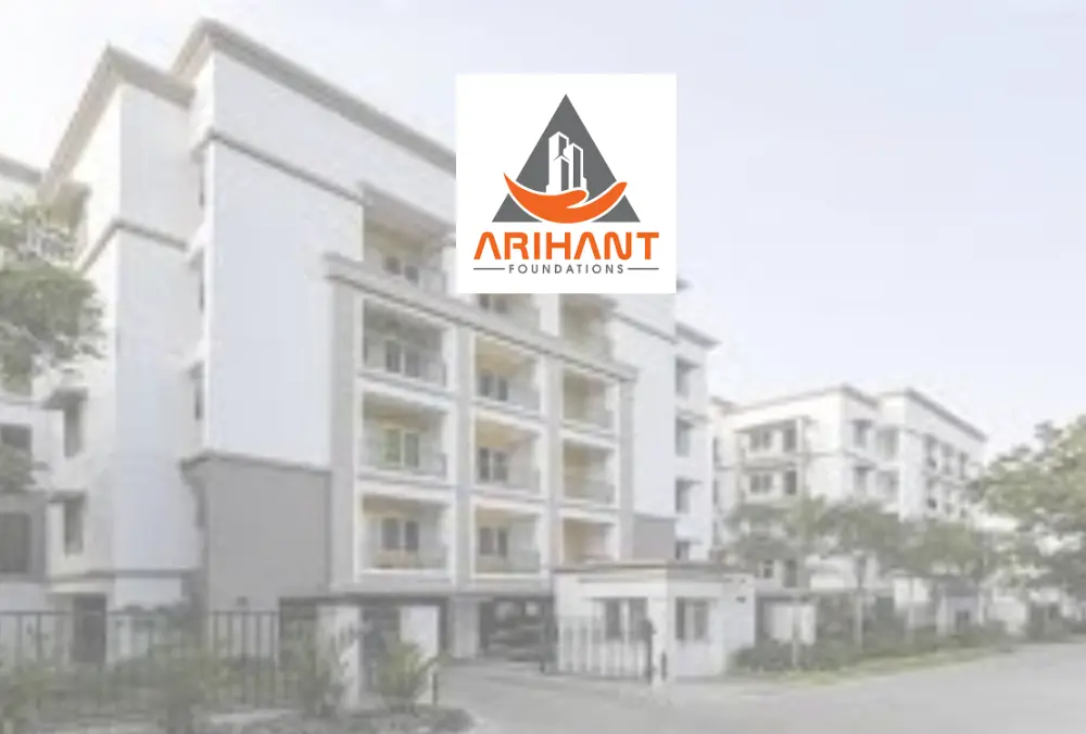 Arihant Foundations logo over modern apartment building complex