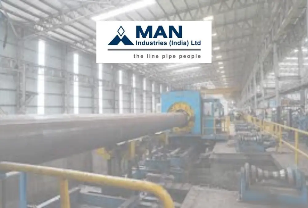 MAN Industries logo over steel pipe manufacturing facility