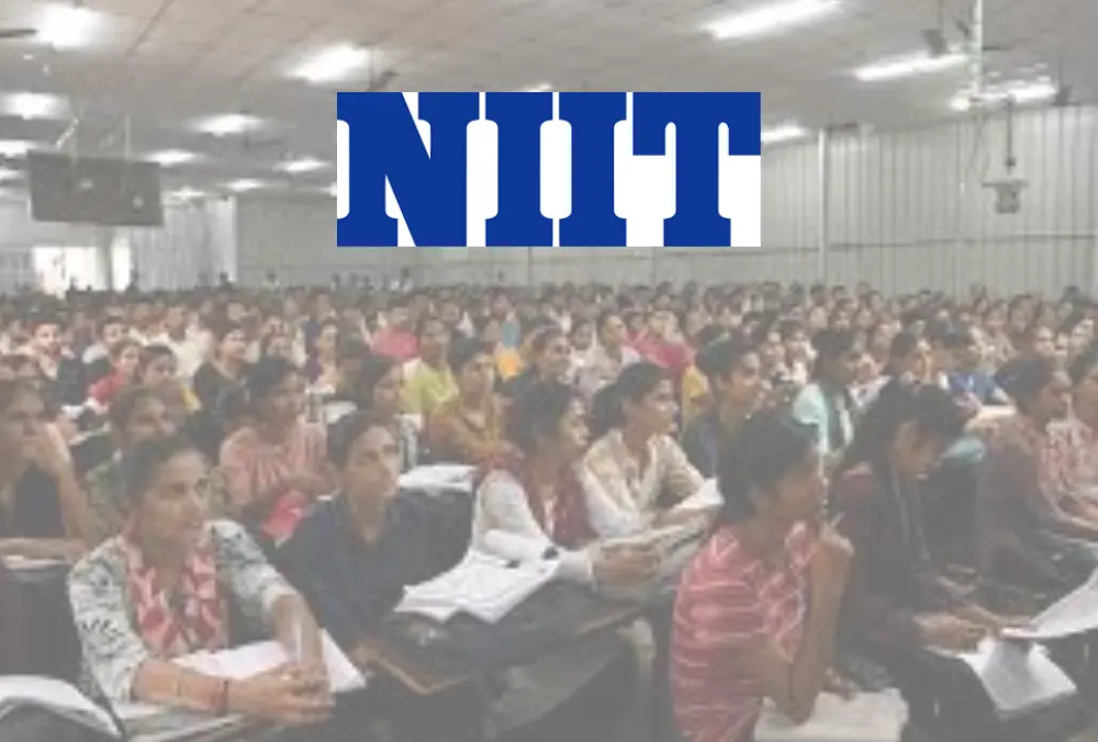 NIIT logo over classroom with students attending training