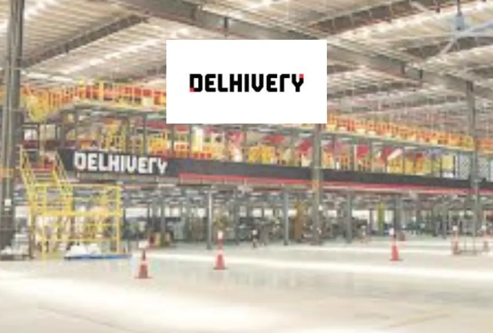Delhivery logo displayed over a large logistics warehouse interior